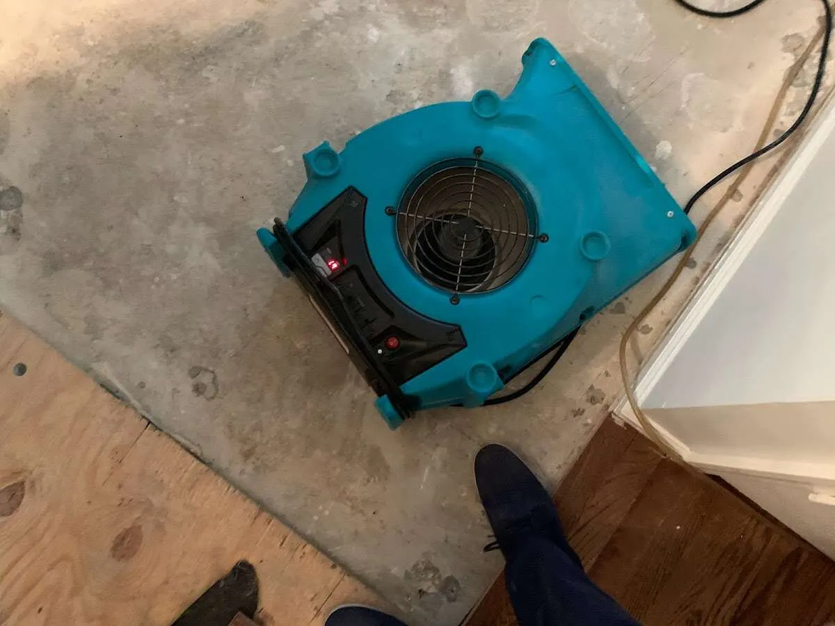 Air mover drying subfloor during Commercial Water Damage Restoration in Ellettsville